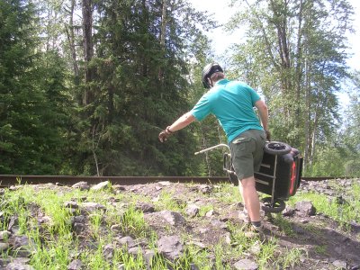 Dennis is carrying the Suitcase Trailer over the tracks.